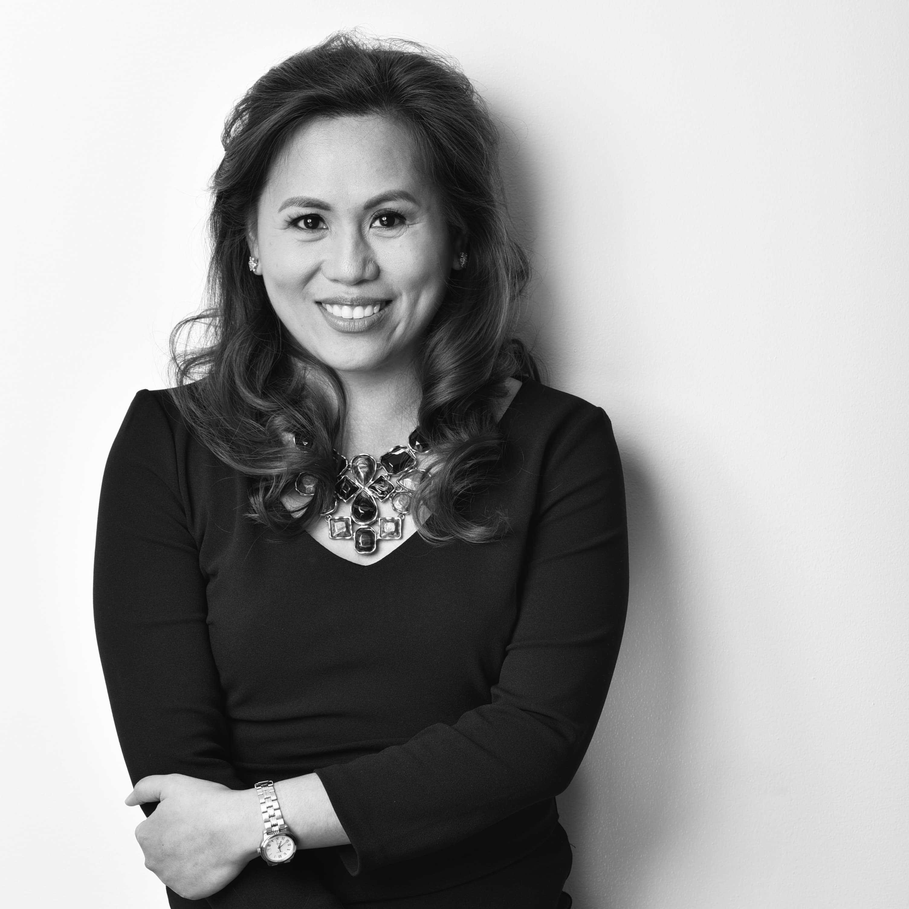 Professional portrait of Katherine Garcia, a healthcare marketing consultant, in professional attire against a neutral architectural background